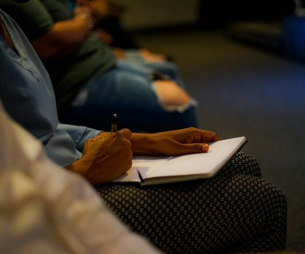 Photo by Tai's Captures person holding pen and white paper on person lap